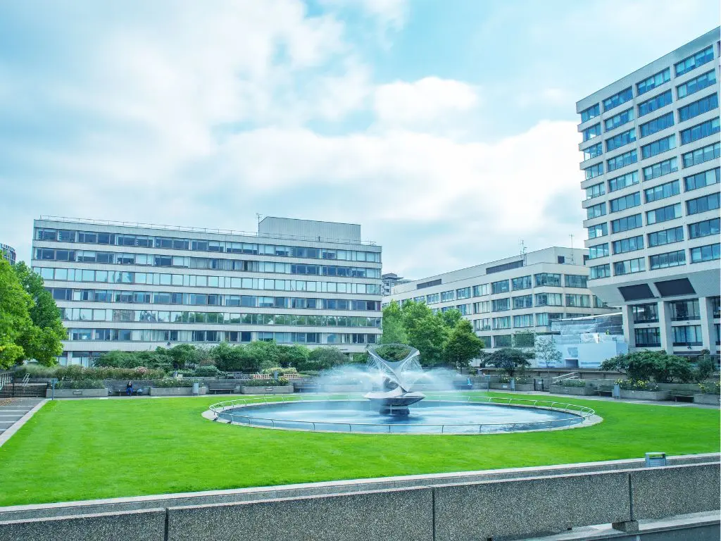 big fountain in the middle of grassy landscape