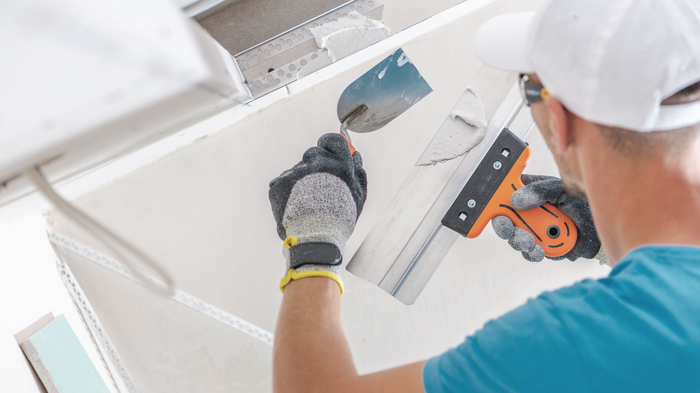 man painting the ceiling with white