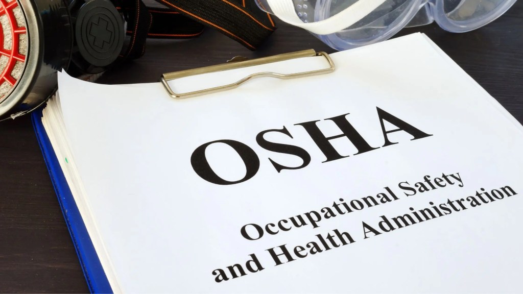 a clipboard with the word OSHA on the top paper