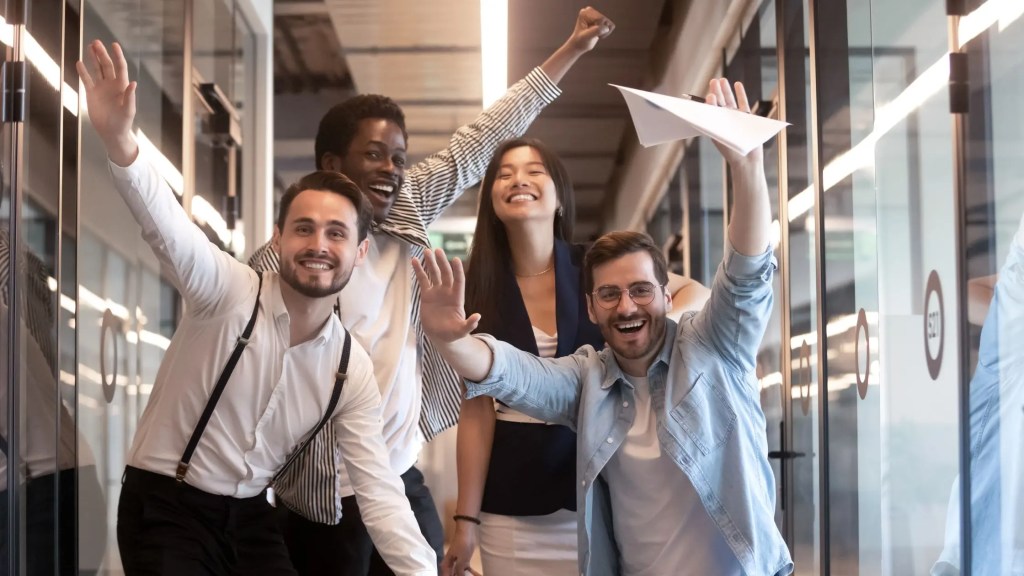 four employees celebrating