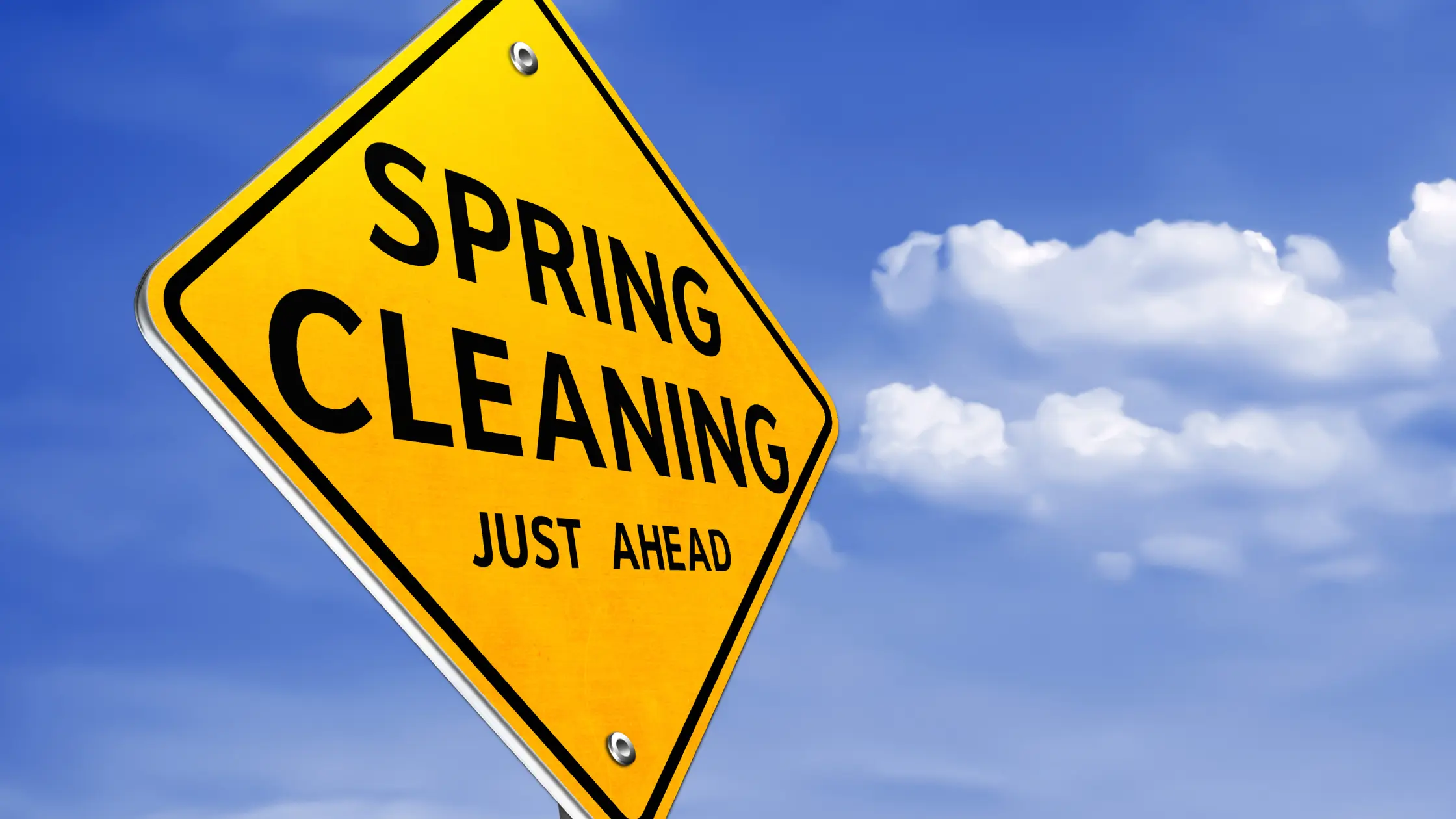 road sign saying spring cleaning just ahead